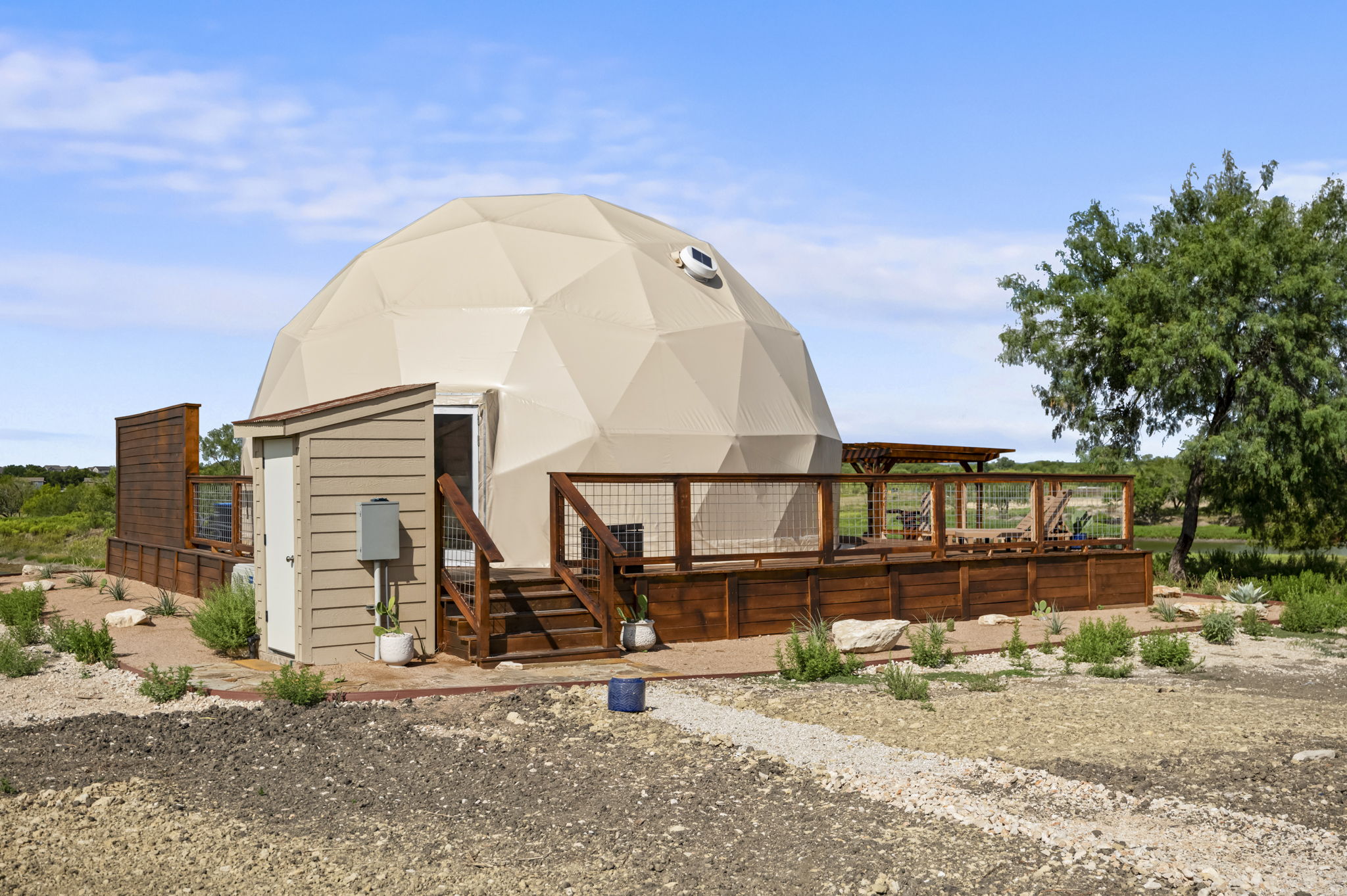 Glamping dome exterior overlooking the pond