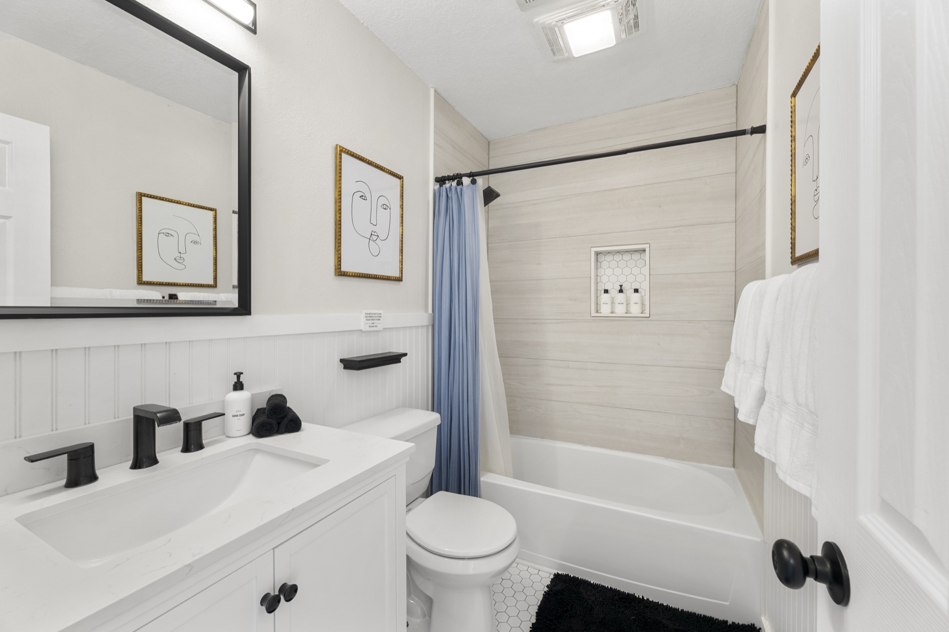 Bathroom with shiplap tub surround and black fixtures