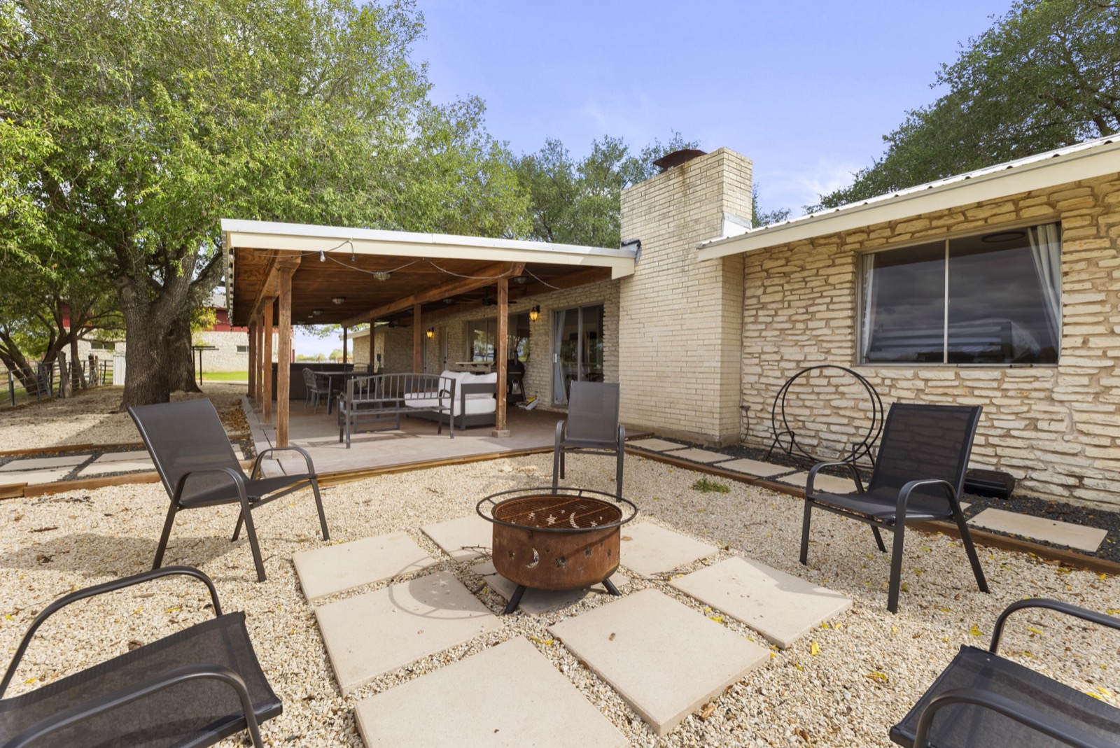 Fire pit seating area with chairs and covered patio