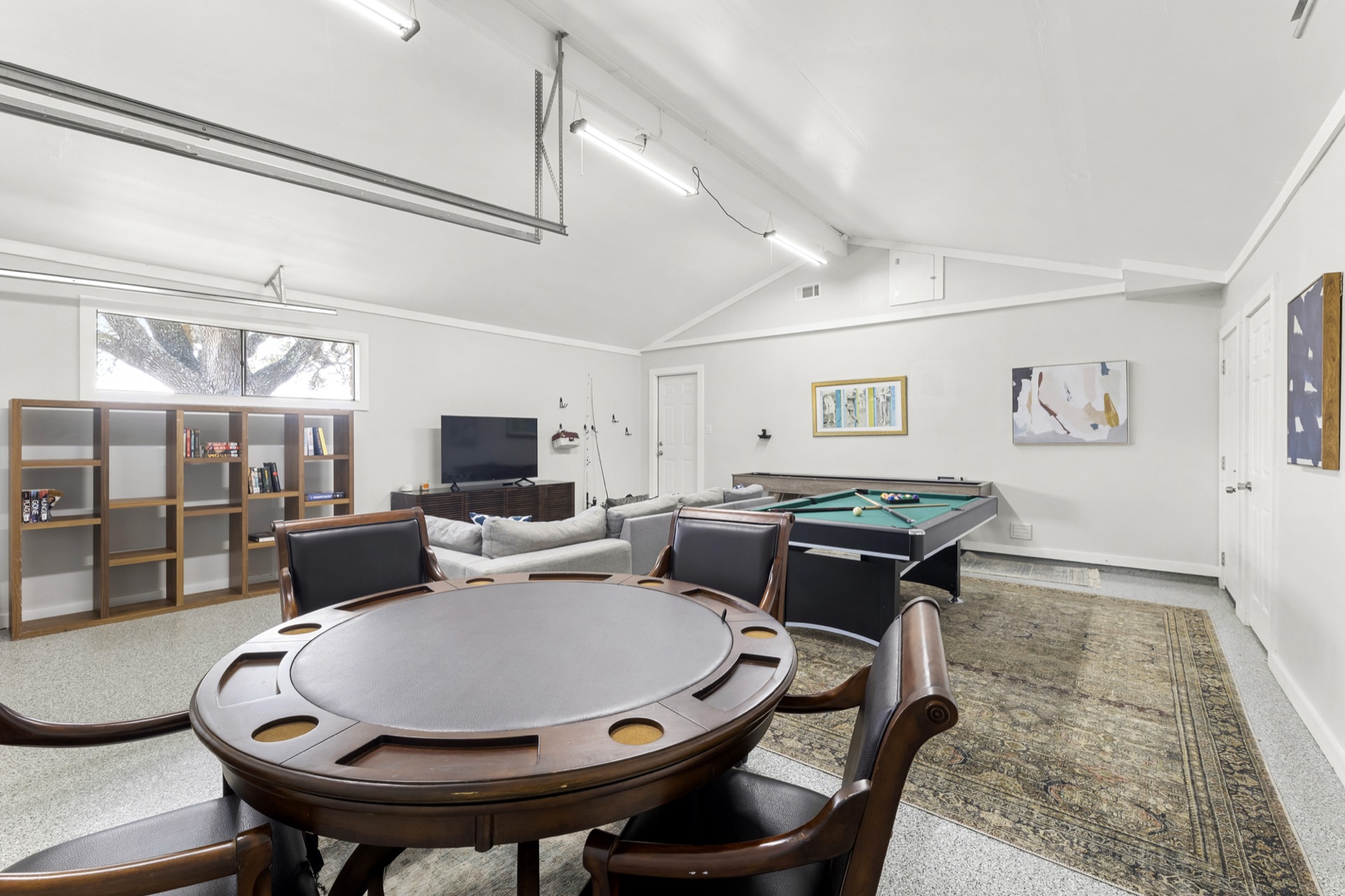 Game room with poker table, bookshelf, and entertainment area