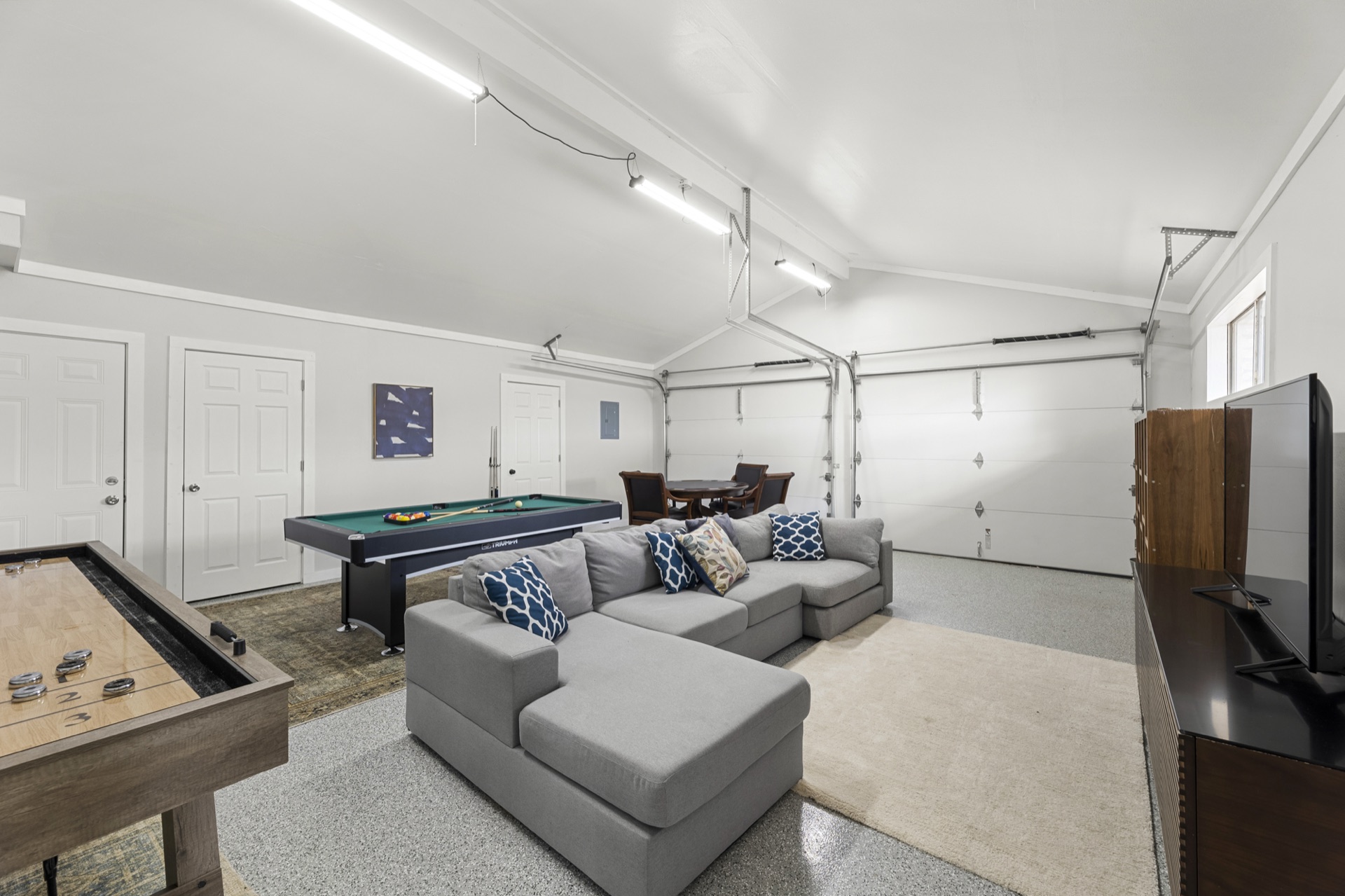 Game room with pool table, shuffleboard, and TV lounge